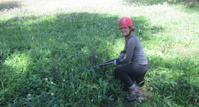 A person uses garden tools during a service project with outward bound